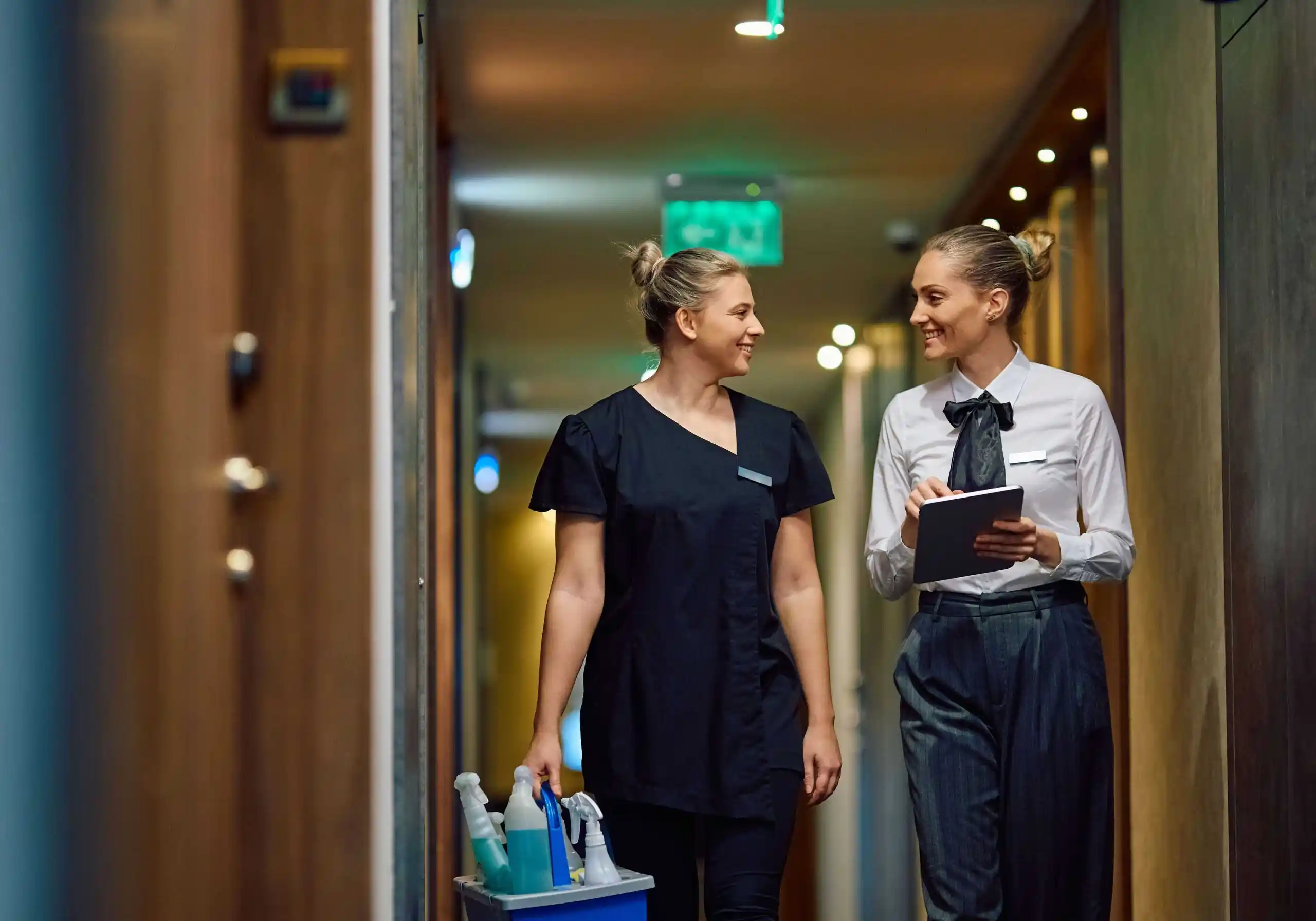 Cleaning staff managing service tasks with cart and supplies at Ecorens.